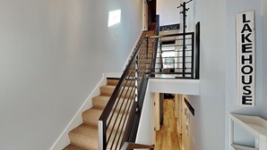 A staircase with a handrail, carpeted steps, and a sign reading "LAKE HOUSE". - Arrowhead Village 13 by Taylor Made Deep Creek (Oakland)