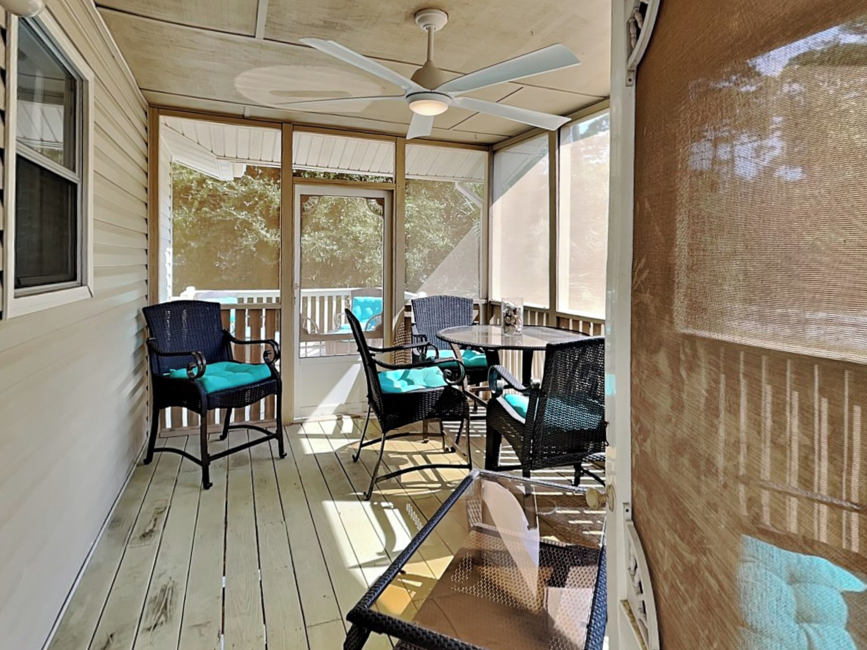 A covered patio with outdoor furniture, a ceiling fan, and a view of the outdoors.