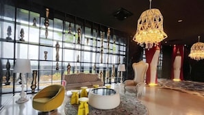 A modern interior with a large window, a round coffee table, and a yellow armchair. - Arte Mont Kiara By Yan Yee (Kuala Lumpur)