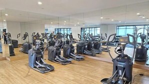 A gym with multiple elliptical machines arranged in rows. - The Establishment Menara Teguh Bangsar Menara UOA KL Sentral (Kuala Lumpur)