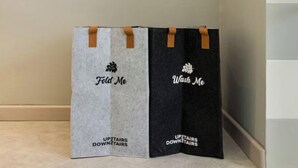 Two bags with handles, one labeled 'Fold Me' and the other 'Wash Me,' both with 'UPSTAIRS DOWNSTAIRS' text. - Upstairs Downstairs CoLiving Bukit Bintang (Kuala Lumpur)