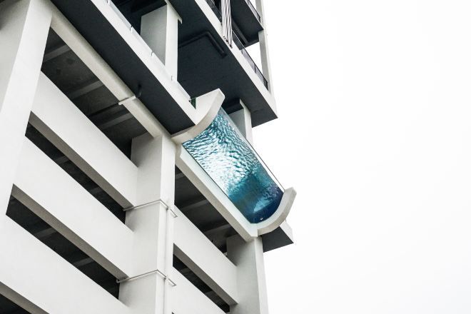 A modern building with a distinctive glass facade and a geometric design.
