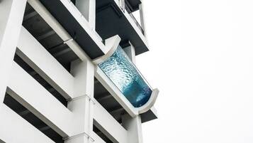 A modern building with a distinctive glass facade and a geometric design.