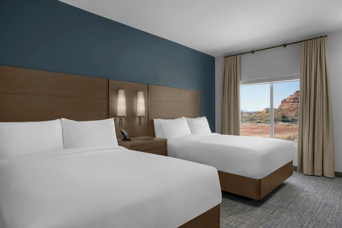 Premium bedding, desk, laptop workspace, blackout drapes