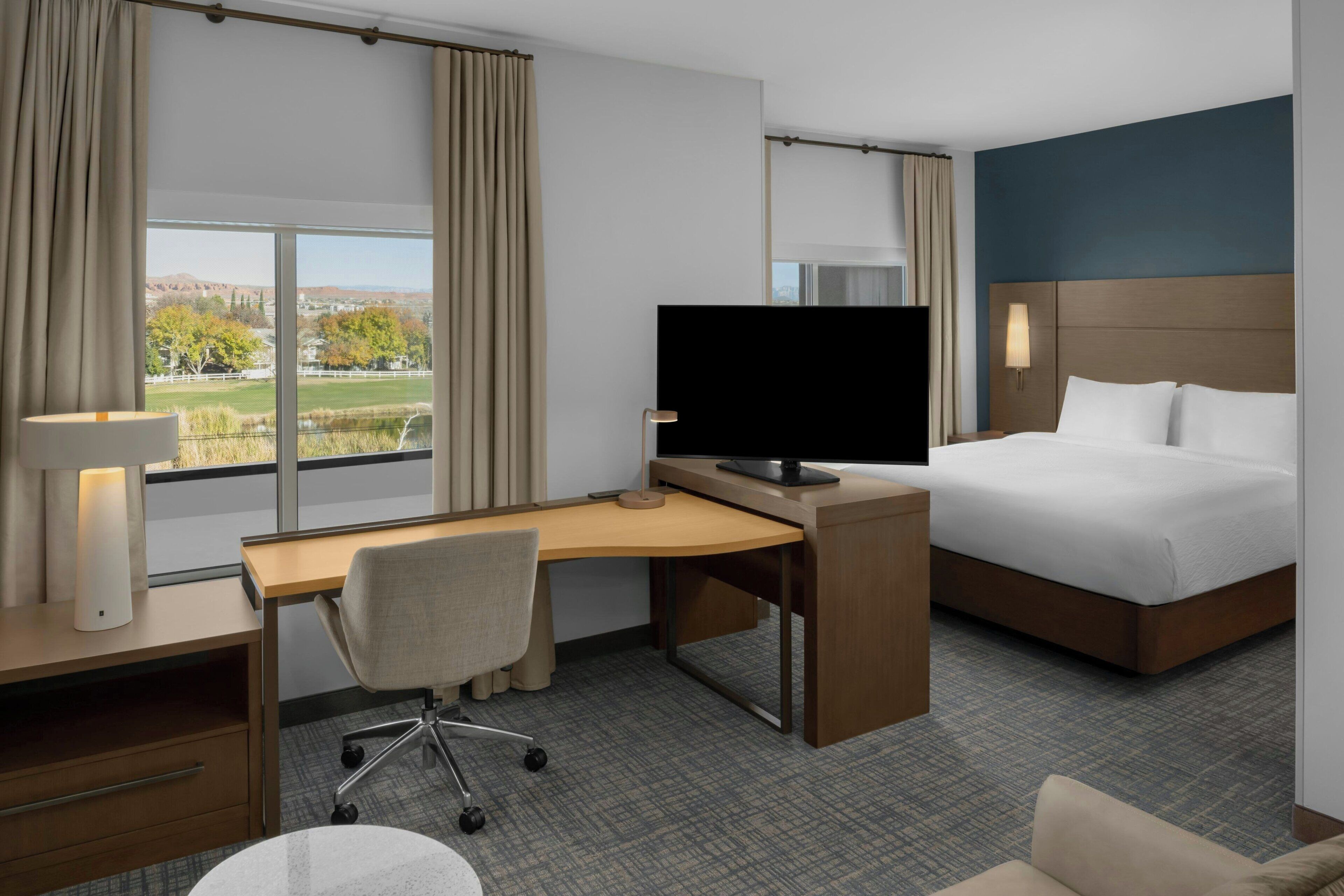 Premium bedding, desk, laptop workspace, blackout drapes