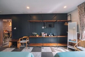 A room with a checkered floor, a wooden bench, a chair, a white cabinet, and a television mounted on the wall. - An Phu House Valley View (Dalat)