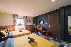 A hotel room with two beds, a desk, a chair, a wardrobe, and a television. - An Phu House Valley View (Dalat)