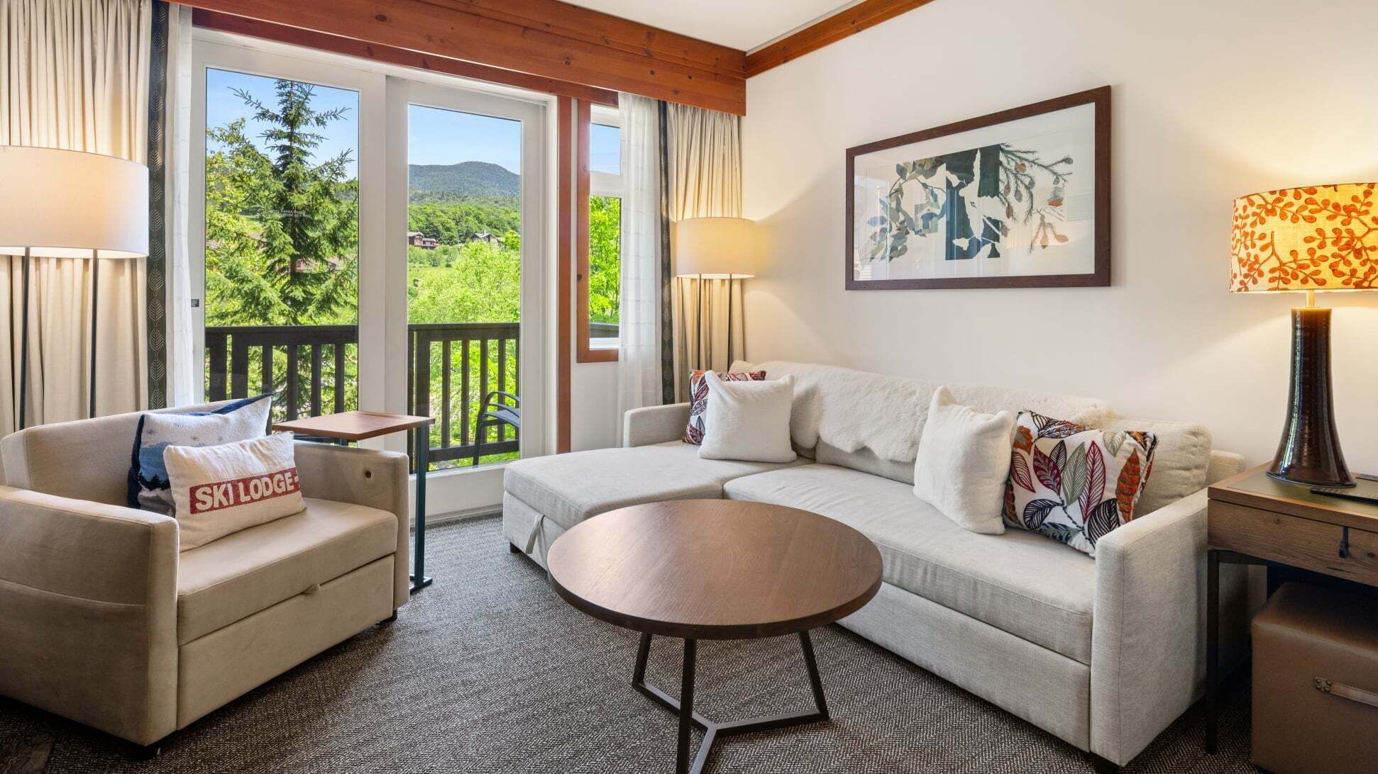A cozy room with a sofa, a small table, and a lamp.