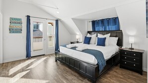 A bedroom with a bed, nightstands, a dresser, and a view of a balcony. - Stunning beach home located between bay and beach w/ Ocean View Patio (San Diego)