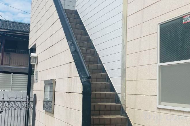 A residential building with a staircase leading to the entrance.