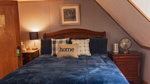 A bedroom with a wooden headboard, a blue bedspread, and a pillow with the word "home". - Aspen Room Serene Retreat at Columbine (Silverton)