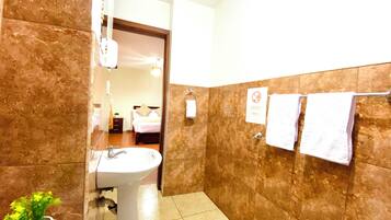 Een douche, handdoeken, zeep, shampoo