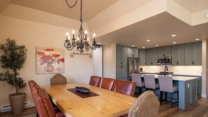 A modern kitchen with grey cabinets, stainless steel appliances, and a central island. - Experience comfort in this 2-bedroom condo at Purgatory Village, Durango. (Durango)