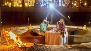A cozy outdoor dining area with a fire pit, a table with a white tablecloth, and a view of the hotel's interior. -  Available Oct.22-28th Luxury at its finest!!! 1-Bedroom, 1300 sq ft Condo, (Cabo San Lucas)