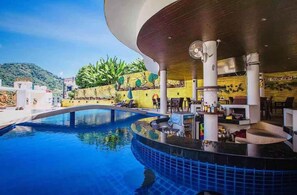 A pool area with a curved roof, lounge chairs, and a bar area.