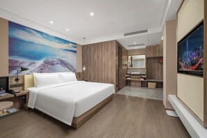 A modern hotel room with a large bed, a bathroom with a mirror and sink, and a wall-mounted TV. - Mehood Lestie International Hotel Shenzhen Science and Technology Park Hi-Tech Central Metro Station Branch (Shenzhen)