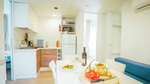 A compact kitchen with a dining area.