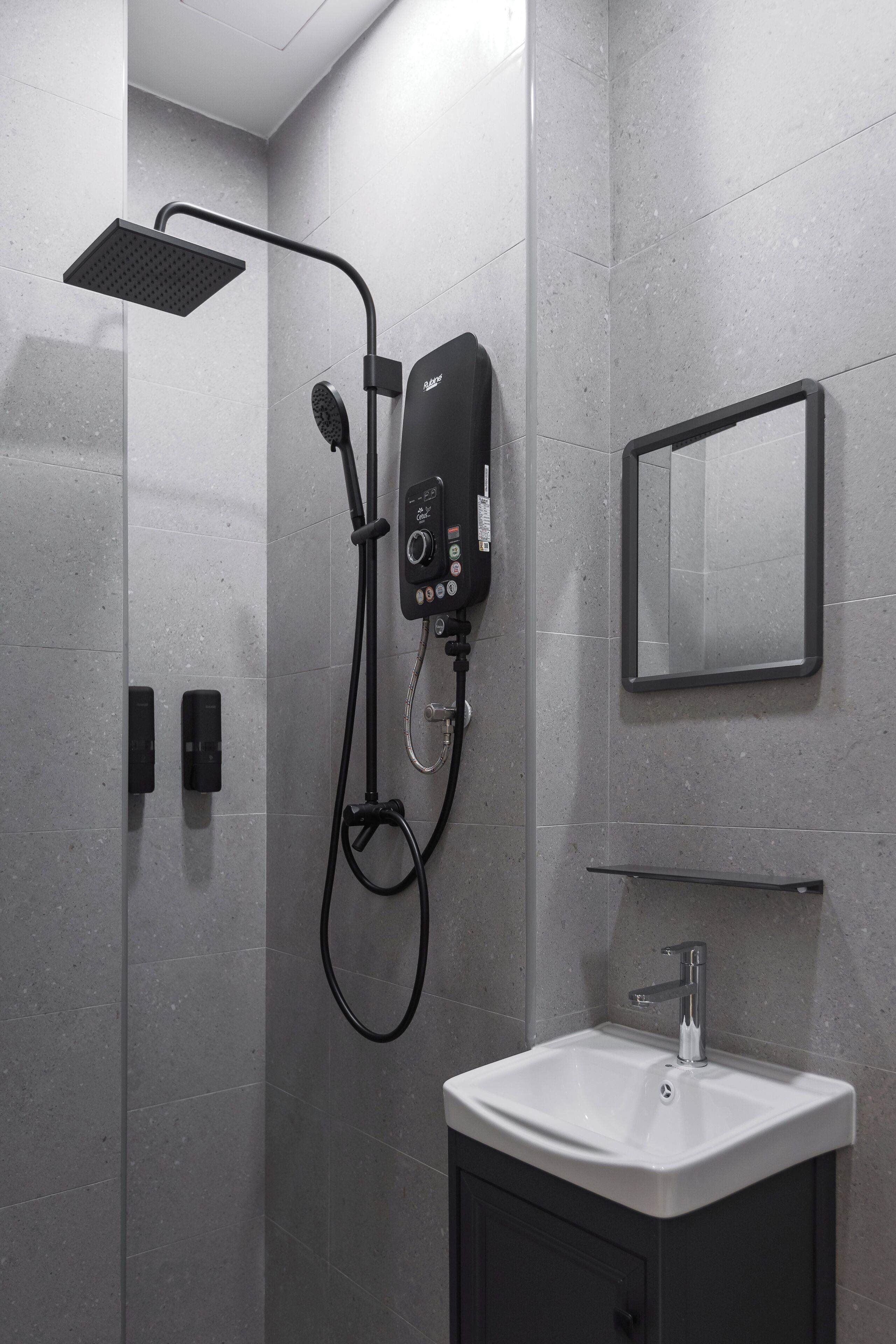 A modern bathroom with a shower, a sink, and a mirror.
