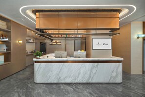 A modern kitchen with marble countertops, stainless steel appliances, and a central island. - Licheng Platinum Hotel (Guangzhou)