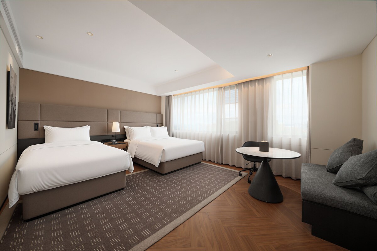 Family Twin Room, City View | Down comforters, minibar (free items), laptop workspace, blackout drapes