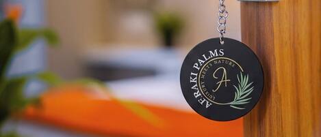 A keychain with 'AEROPALMS' and a palm tree logo, attached to a door handle.