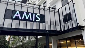 A modern hotel with a prominent 'AMIS' sign on the entrance. - AMIS By Sima Thani (Nakhon Ratchasima)