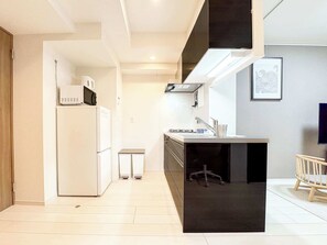 Fridge, microwave, coffee/tea maker, cookware/dishes/utensils