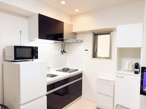 Fridge, microwave, coffee/tea maker, cookware/dishes/utensils