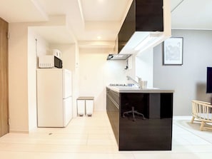 Fridge, microwave, coffee/tea maker, cookware/dishes/utensils