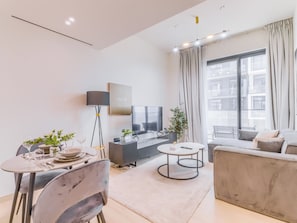 Apartment, Balcony, City View | Living area | 55-inch Smart TV with digital channels