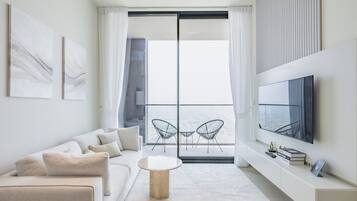 Deluxe Apartment, Balcony, City View | Living area | 55-inch Smart TV with digital channels