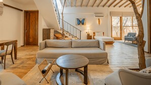 A spacious living area with a sofa, coffee table, and a staircase leading to an upper level. - O2 Villas Yala (Yala)