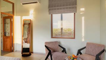 Deluxe Villa | Living area | 42-inch LED TV with cable channels