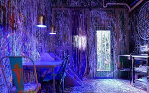A room with a rustic aesthetic, featuring a wooden table, chairs, and a window with curtains. - Beverly Hills Spanish (Beverly Hills)