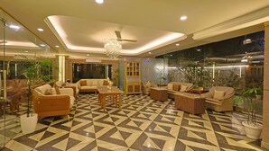A spacious lobby with a geometric patterned floor, comfortable seating areas, and a chandelier. - FlxHo Horizon ONE - Luxury Hotel & Residences Golf Course Road, 2 Min from 42-43 Metro Station (Gurugram)