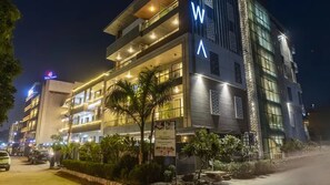 A multi-story hotel with balconies, a sign for relaxing rooms and memorable events, and a visible logo on the building. - Hotel Bawa Gurgaon, Medanta (Gurugram)