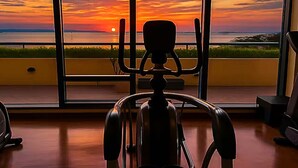 A room with a view of a sunset over the ocean, a chair, and a desk. - Seaside Escape in Front of US Embassy (Manila)