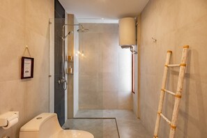 A modern bathroom with a shower, toilet, and a ladder.