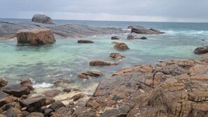 A rocky shoreline with clear turquoise water and large boulders. - Ace on Par - Central Dunsborough (Dunsborough)