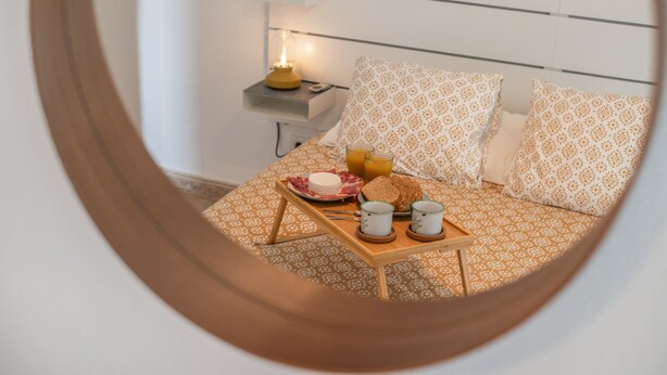 A bedroom with a bed, bedside table, lamp, and breakfast tray. - Holiday Home '2' with Wi-Fi and Air Conditioning (El Golfo)