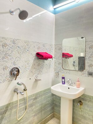 A bathroom with a shower, sink, and mirror. - Let'stay- Sector 63A Noida (Noida)