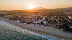 A coastal hotel with multiple buildings, a beachfront, and a pool area. - 6BR Luxe Villa w/ Infinity Pool & Ocean Views (Cabo San Lucas)