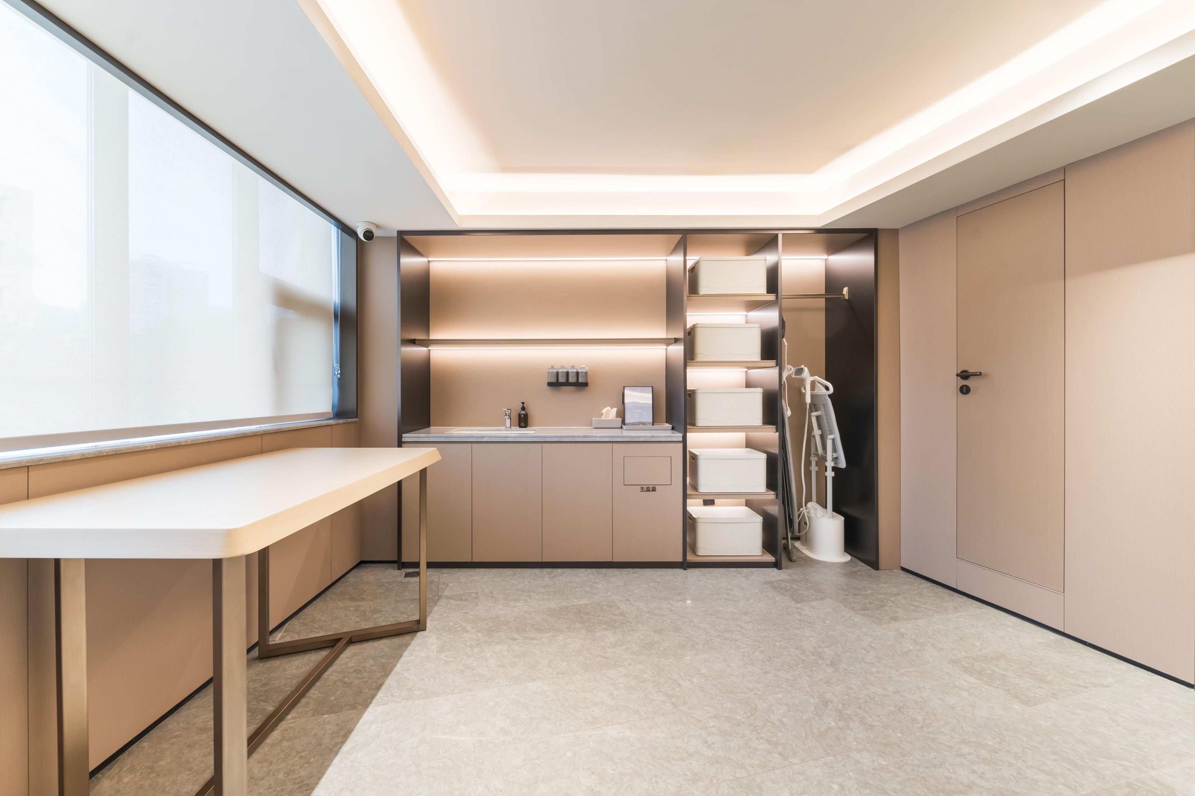 A modern bathroom with a vanity, sink, and towel rack.