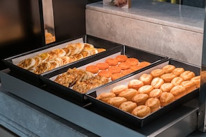 A buffet with various food items including pastries, meats, and vegetables. - Ji Hotel Guangzhou Shayuan Metro Station (Guangzhou)