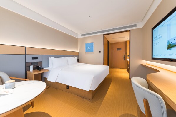 A modern hotel room with a large bed, a desk, and a television. - Ji Hotel Guangzhou Shayuan Metro Station (Guangzhou)