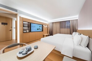 A modern hotel room with a large bed, a desk with a tray of items, a television mounted on the wall, and a window with curtains. - Ji Hotel Guangzhou Jiangnanxi Metro Station (Guangzhou)