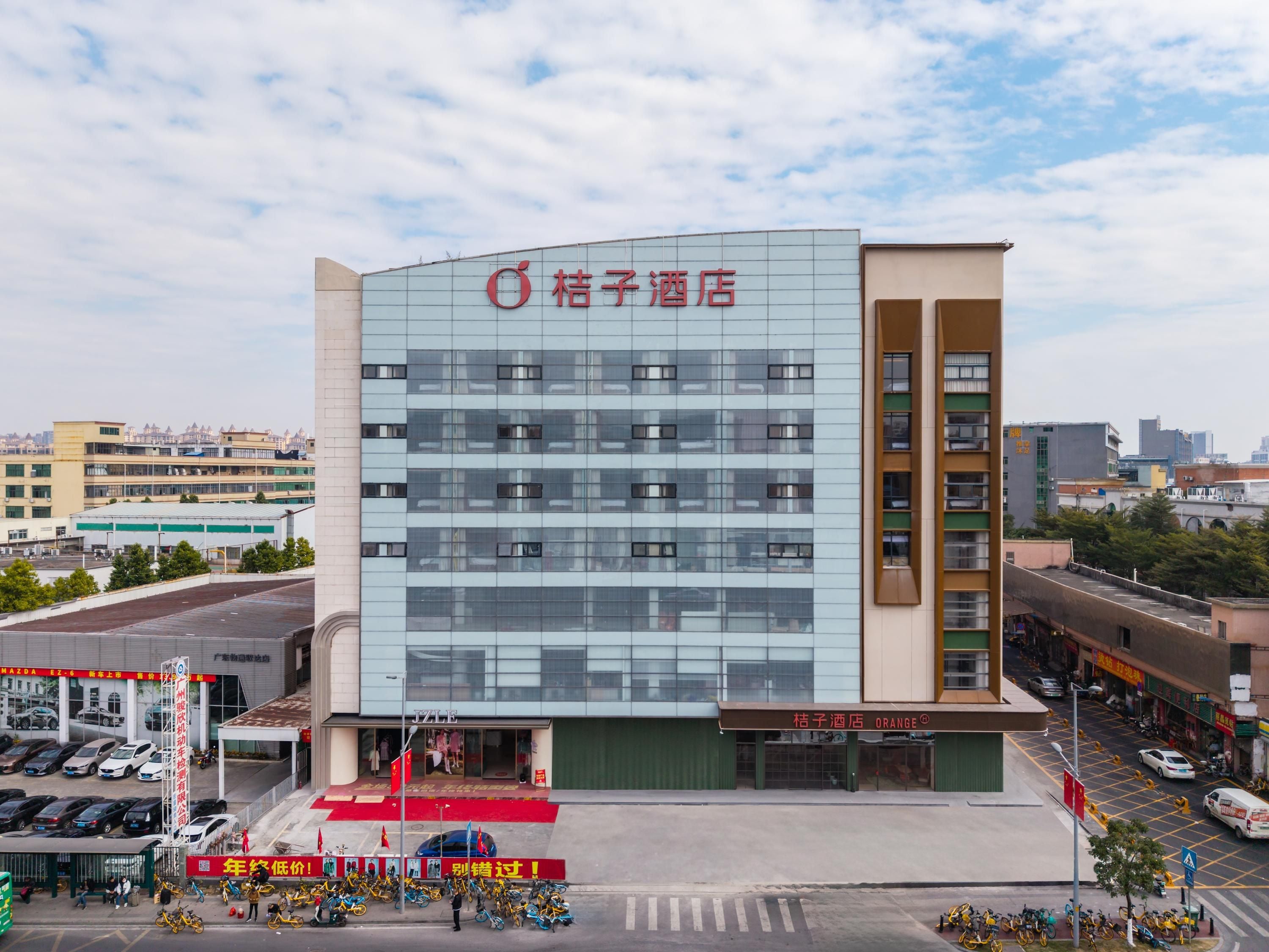 A hotel with a modern facade, multiple floors, and a prominent signage.