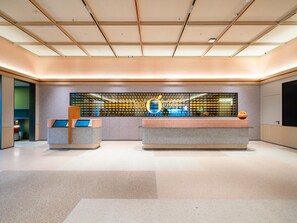 A modern reception area with a large digital display and two reception desks. - Orange Guangzhou Panyu Chimelong Wanbo Center (Guangzhou)