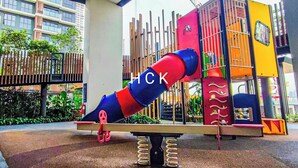 A playground with a slide and climbing structures. - KL City View at Trion 2 by HCK (Kuala Lumpur)