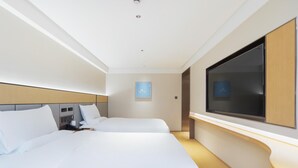 A modern hotel room with two beds, a flat-screen TV mounted on the wall, and a bedside table. - Ji Hotel Guangzhou Baiyun Airport Terminal 2 (Guangzhou)
